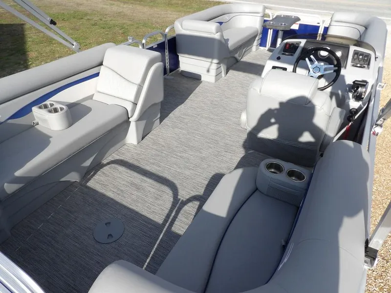 Slide: The Image of 2023 Bennington 20 SVSR pontoon boat interior with gray seating and steering console. - 25