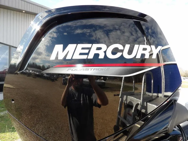 Slide: The Image of Mercury FourStroke engine on 2023 Bennington 20 SVSR boat, reflecting sky and surroundings. - 26