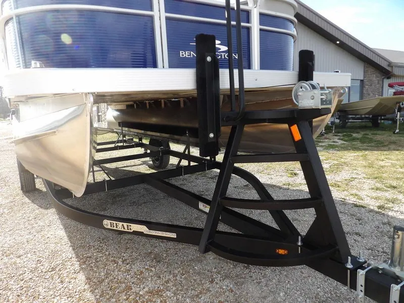 Slide: The Image of 2023 Bennington 20 SVSR pontoon boat on a trailer, parked outdoors. - 30