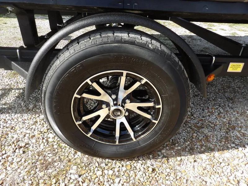 Slide: The Image of 2023 Bennington 20 SVSR trailer wheel on gravel surface. - 32