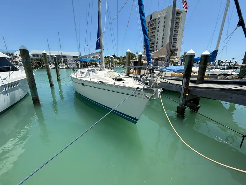 Slide: The Image of Sailboat Jeanneau Sun Odyssey 42.2, 1998, docked in clear turquoise water at marina. - 12