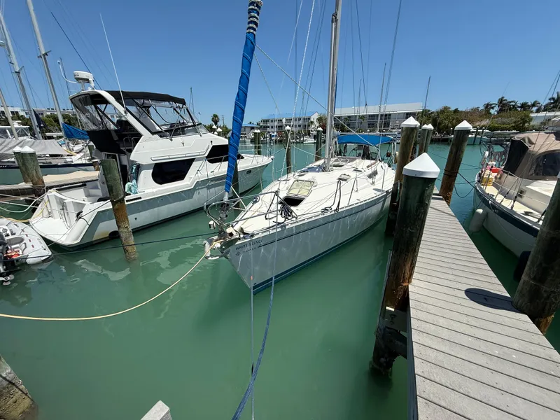 Slide: The Image of Jeanneau Sun Odyssey 42.2 sailboat docked in a marina, 1998 model. - 15