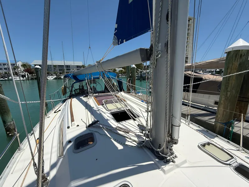 Slide: The Image of 1998 Jeanneau Sun Odyssey 42.2 sailboat docked in a marina under clear blue skies. - 22