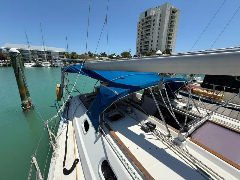 Slide: The Image of 1998 Jeanneau Sun Odyssey 42.2 sailboat docked in marina, blue canopy, clear sky. - 25