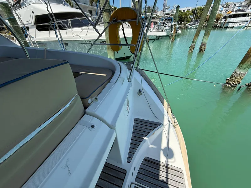 Slide: The Image of 1998 Jeanneau Sun Odyssey 42.2 yacht docked in a marina with turquoise water. - 37