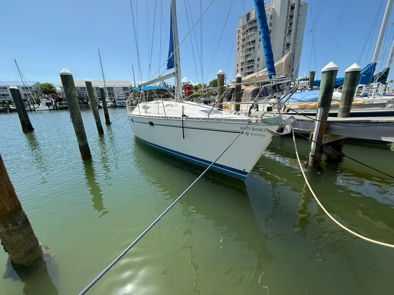 Slide: The Image of 1999 Jeanneau Sun Odyssey 42.2 sailboat docked in marina, clear sky background. - 4
