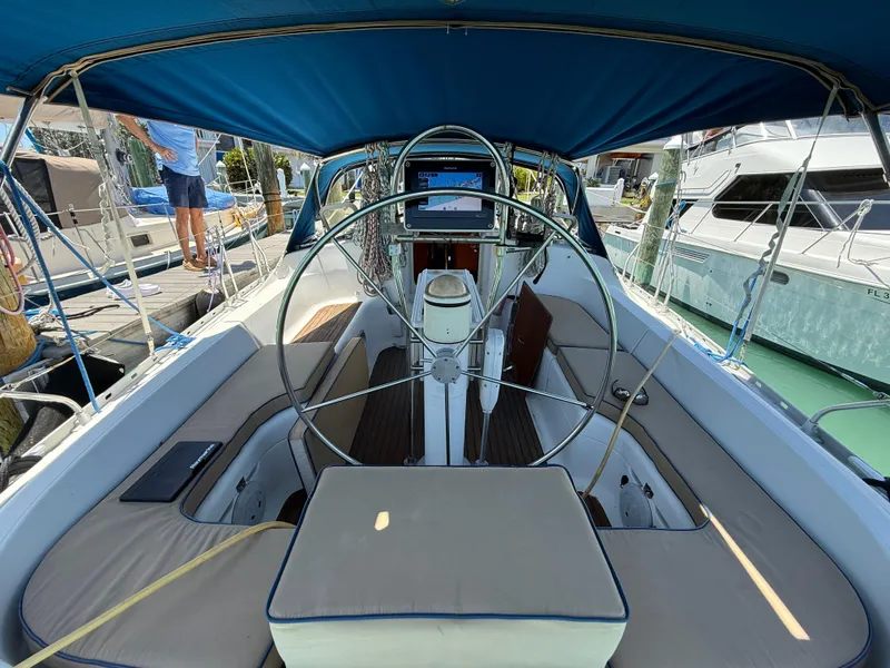 Slide: The Image of Cockpit of 1998 Jeanneau Sun Odyssey 42.2 sailboat with blue canopy and steering wheel. - 40