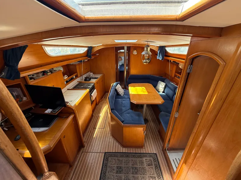 Slide: The Image of 1998 Jeanneau Sun Odyssey 42.2 yacht interior with wood finish and blue seating. - 45