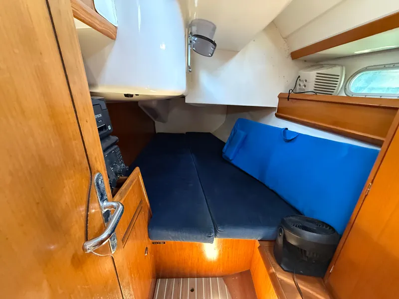 Slide: The Image of Cozy cabin interior of 1998 Jeanneau Sun Odyssey 42.2 sailboat with blue cushions. - 46