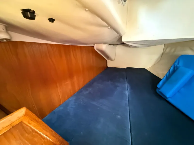 Slide: The Image of Cozy cabin interior of 1998 Jeanneau Sun Odyssey 42.2 sailboat with blue cushions. - 48