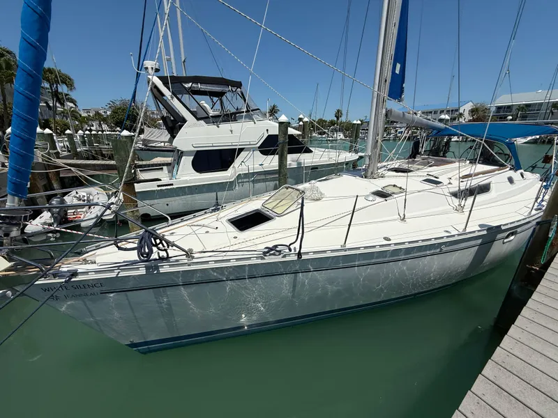 Slide: The Image of 1998 Jeanneau Sun Odyssey 42.2 sailboat docked in a marina under clear blue skies. - 5