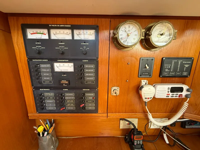 Slide: The Image of Control panel of a 1998 Jeanneau Sun Odyssey 42.2 sailboat with gauges and communication equipment. - 50