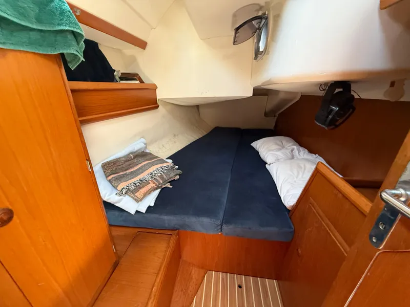Slide: The Image of Cozy cabin interior of 1998 Jeanneau Sun Odyssey 42.2 sailboat with blue cushions. - 52