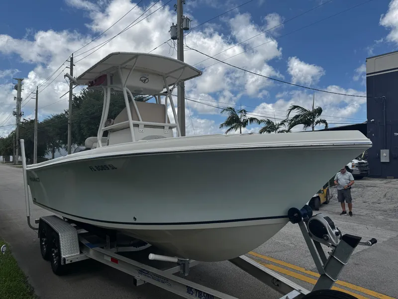 Slide: The Image of 2015 Sailfish 220 CC boat on trailer under blue sky with clouds. - 1