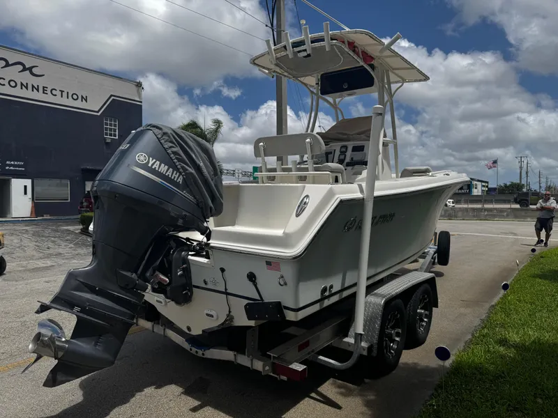 Slide: The Image of 2015 Sailfish 220 CC boat on trailer with Yamaha outboard motor, parked outdoors. - 10