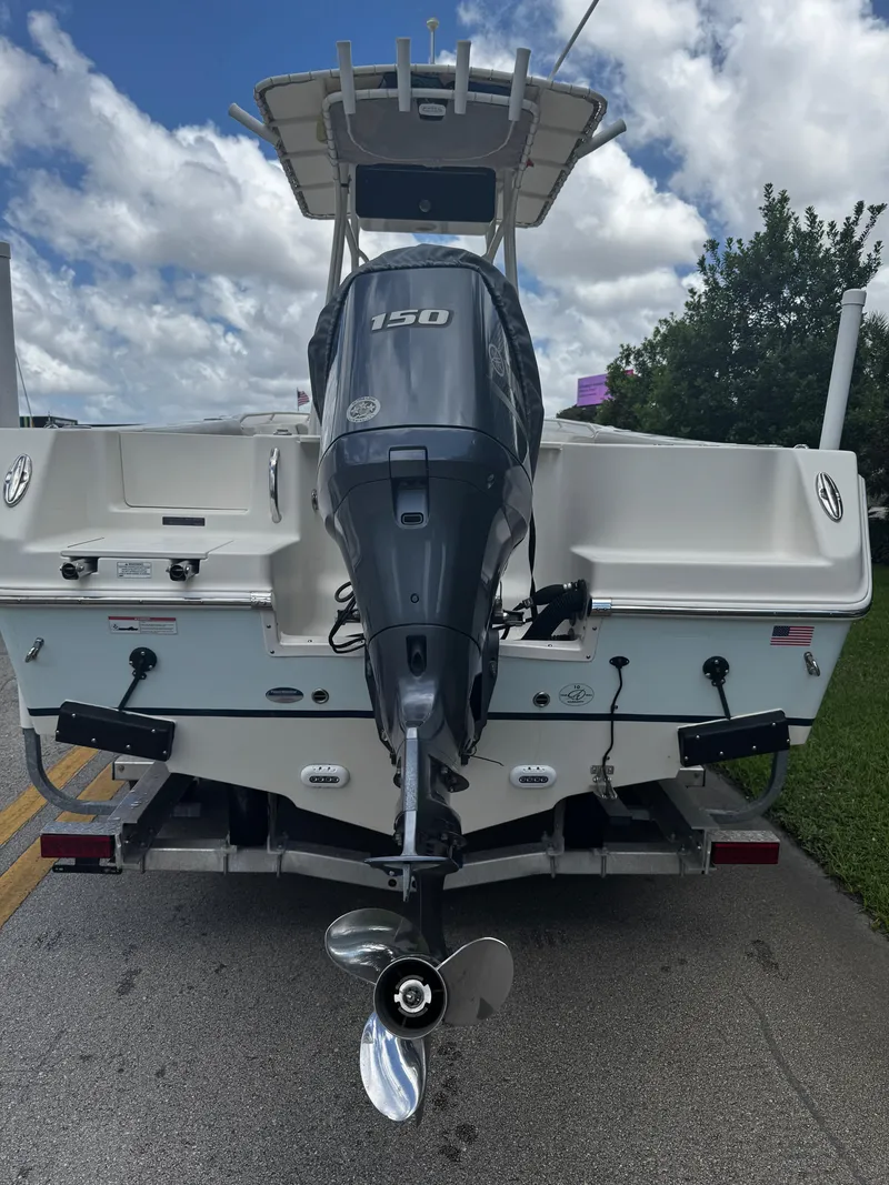 Slide: The Image of 2015 Sailfish 220 CC boat with Yamaha 150 outboard motor, parked on a trailer. - 13