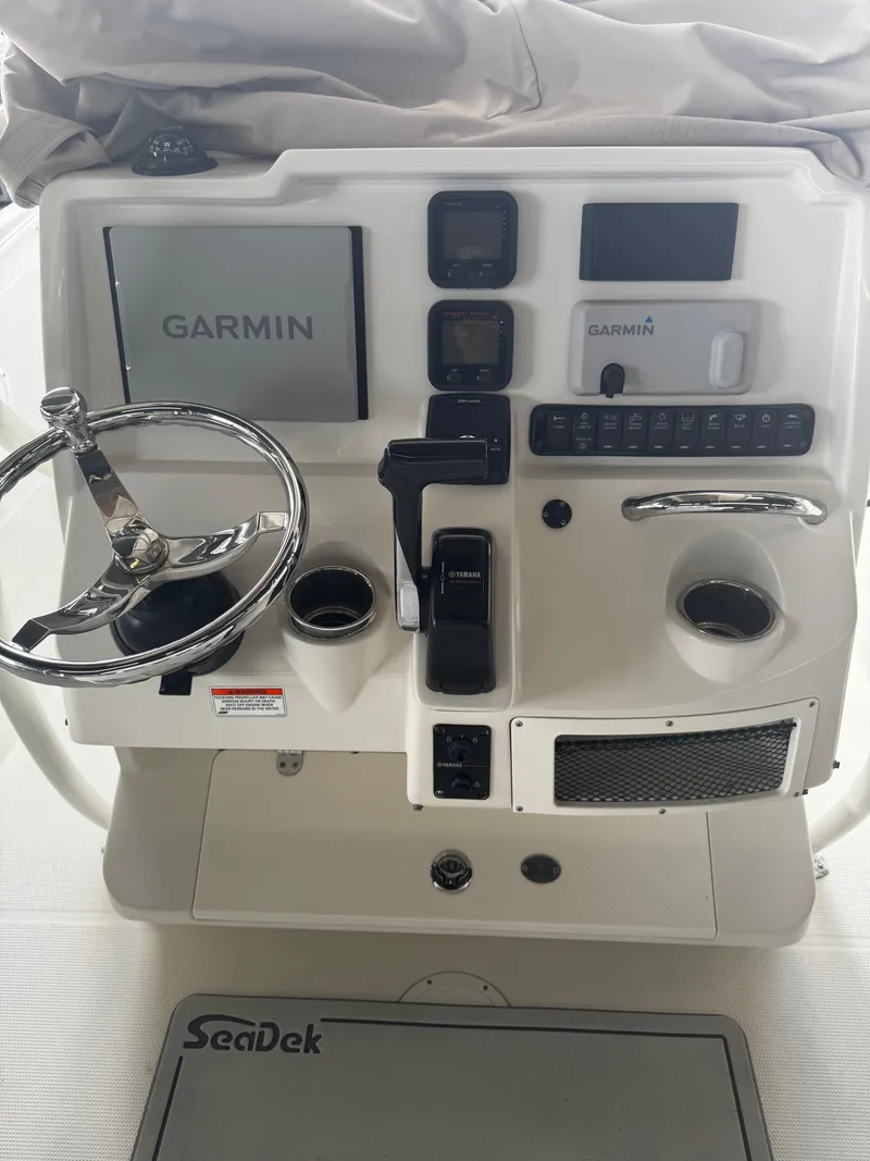 Slide: The Image of 2015 Sailfish 220 CC boat console with Garmin navigation and SeaDek flooring. - 14