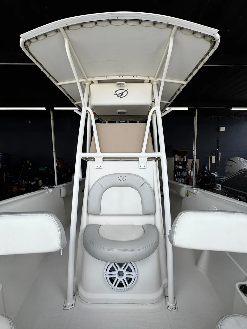 Slide: The Image of 2015 Sailfish 220 CC boat interior with T-top and seating. - 16