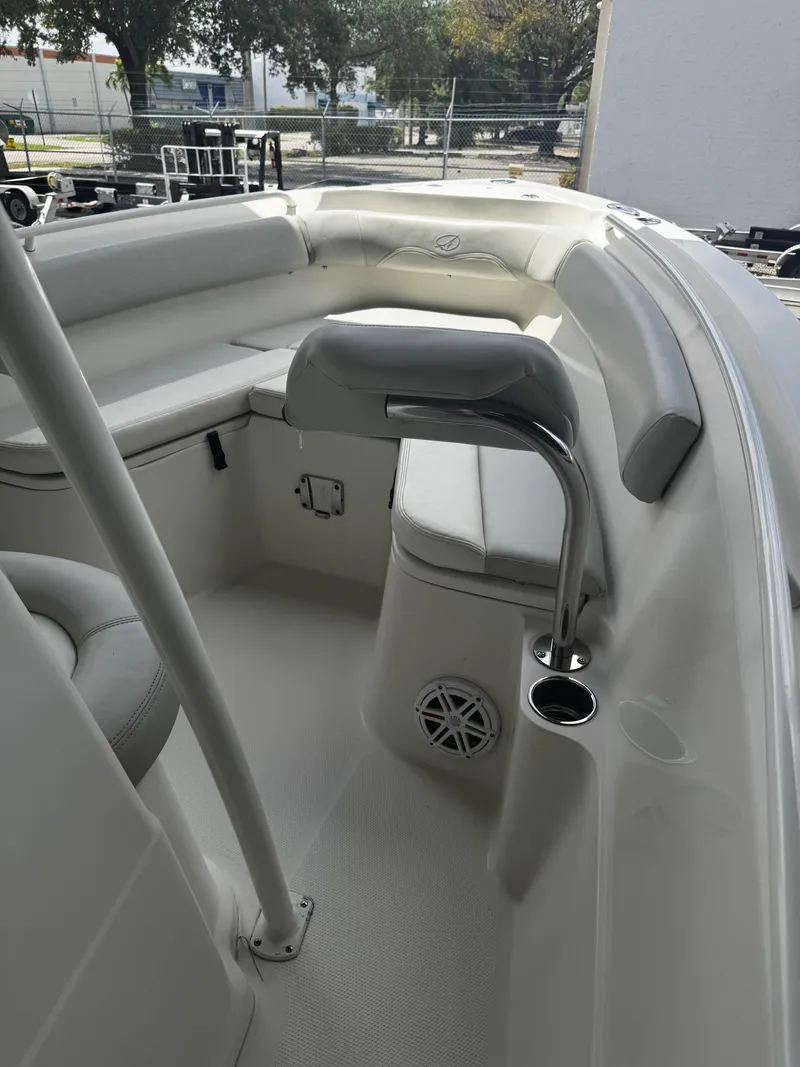 Slide: The Image of 2015 Sailfish 220 CC boat interior with seating and cup holder. - 17