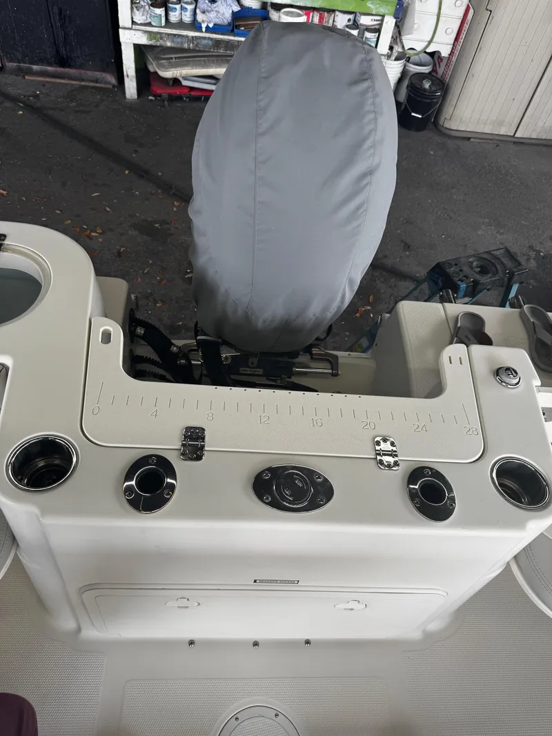 Slide: The Image of 2015 Sailfish 220 CC boat console with covered seat and fishing rod holders. - 18