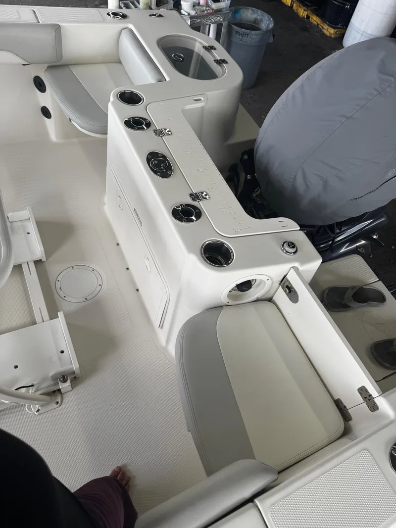 Slide: The Image of 2015 Sailfish 220 CC boat interior with seating and cup holders. - 19