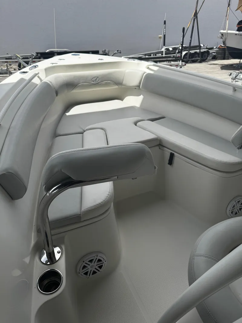 Slide: The Image of 2015 Sailfish 220 CC boat interior with cushioned seating and stainless steel fixtures. - 20