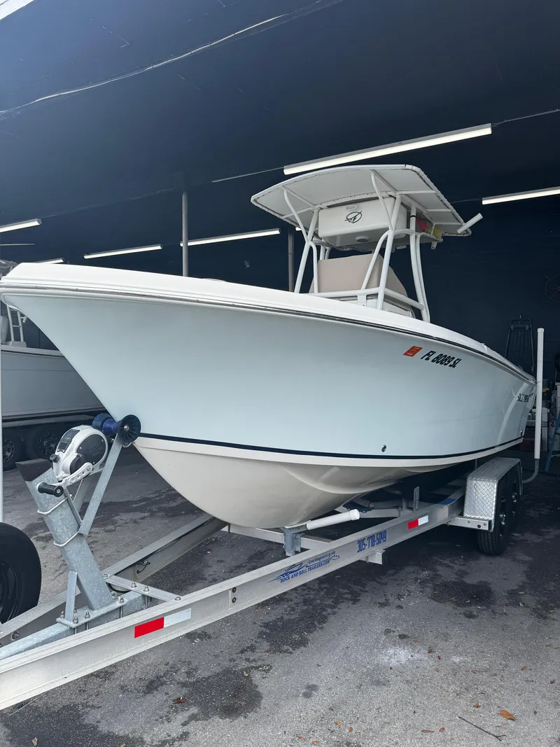 Slide: The Image of 2015 Sailfish 220 CC boat on trailer in a covered storage area. - 22