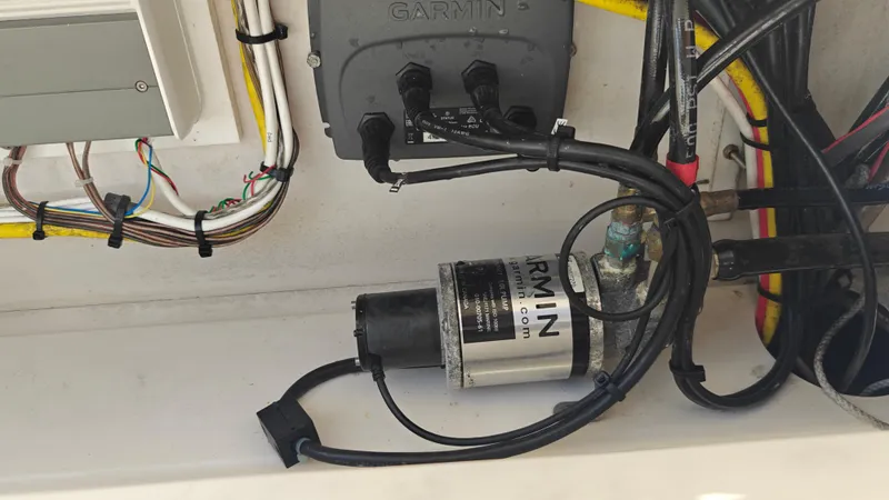 Slide: The Image of Electrical wiring and Garmin equipment inside a 2015 Sailfish 220 CC boat. - 24