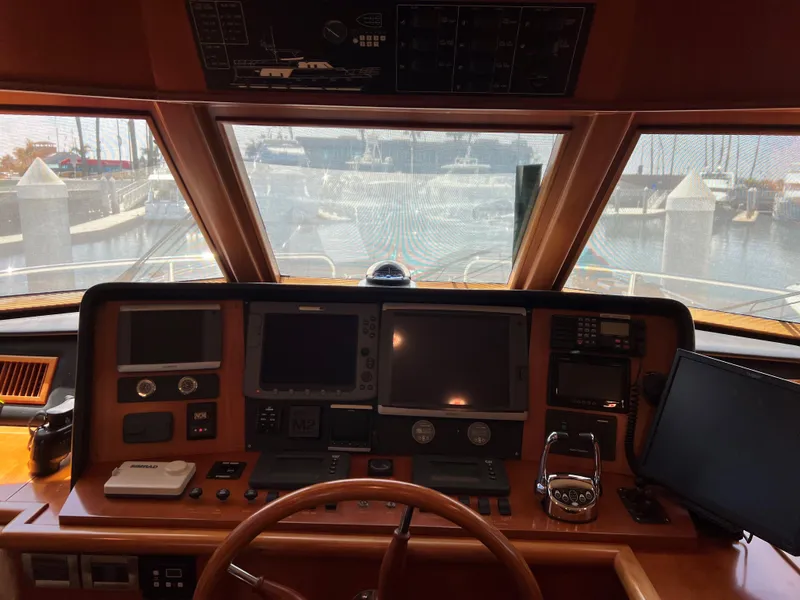 Slide: The Image of Boat cockpit with navigation equipment, steering wheel, and marina view; Symbol PHMY 2007 model. - 10