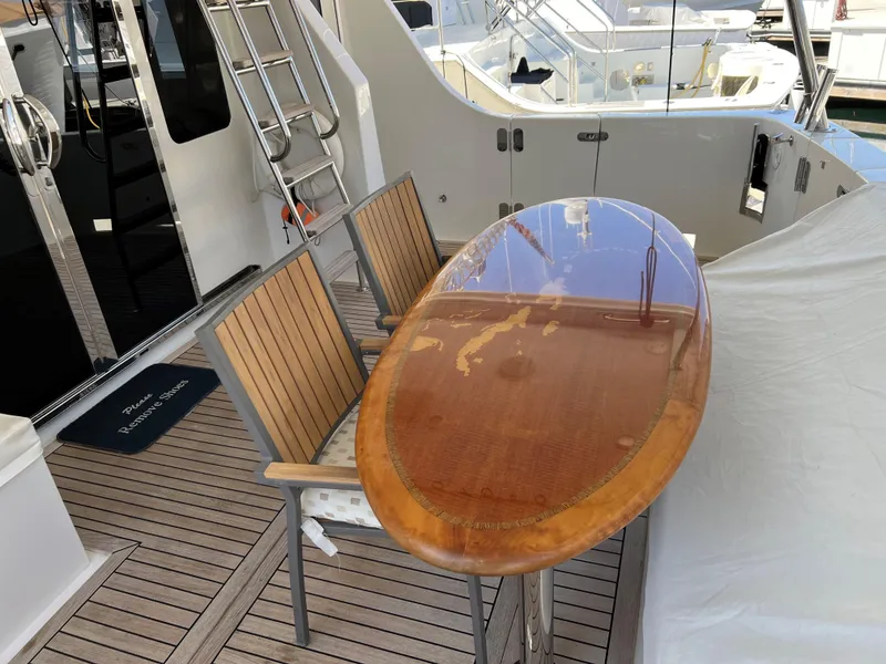 Slide: The Image of Wooden deck with polished surfboard table and chairs on a 2007 Symbol PHMY yacht. - 13