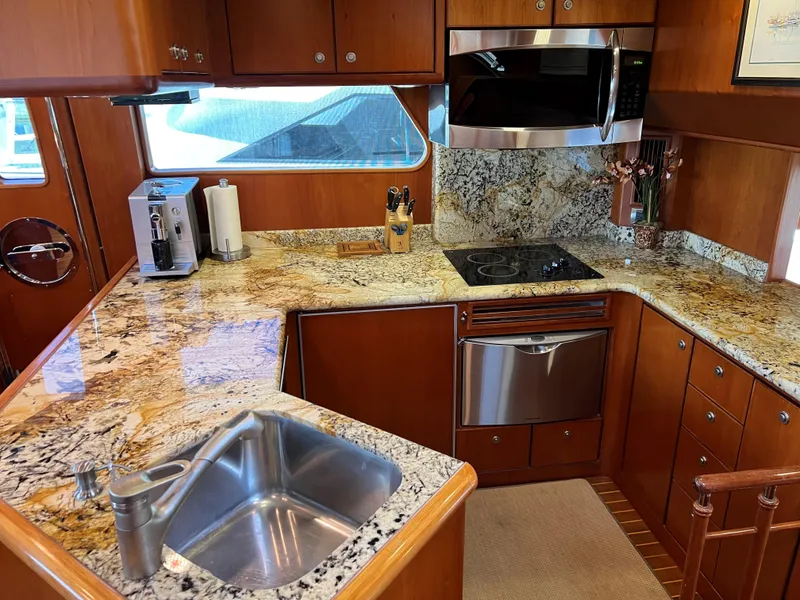 Slide: The Image of Luxurious yacht kitchen with granite countertops, stainless steel appliances, and wooden cabinetry, 2007 Symbol PHMY. - 4