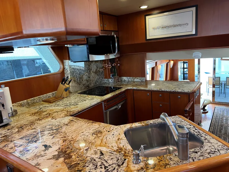 Slide: The Image of Luxurious yacht kitchen with granite countertops, stainless steel appliances, and wooden cabinetry, 2007 Symbol PHMY. - 5