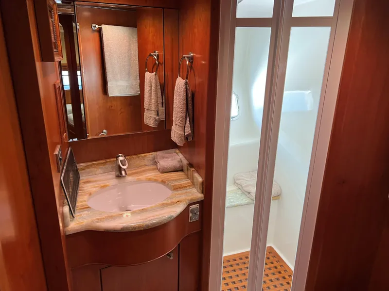 Slide: The Image of Luxurious yacht bathroom with wooden cabinetry, marble sink, and modern fixtures, 2007 Symbol PHMY. - 7