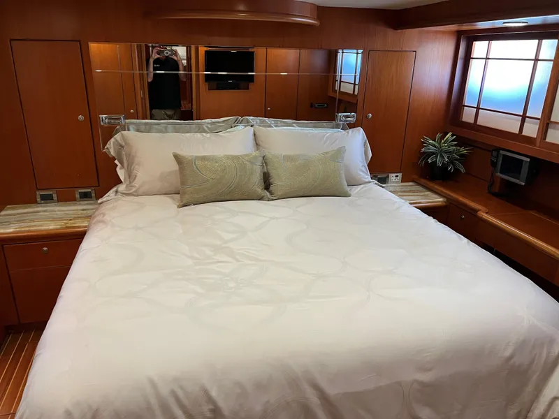 Slide: The Image of Luxurious yacht bedroom with wooden decor, large bed, and elegant bedding, Symbol PHMY 2007 model. - 8