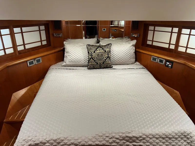 Slide: The Image of Luxurious yacht bedroom with elegant bedding, wood paneling, and decorative pillow, Symbol PHMY 2007. - 9