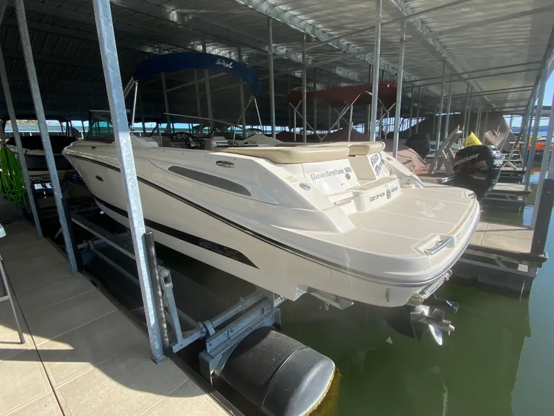 Slide: The Image of 2012 Sea Ray 270 SLX boat docked in a covered marina. - 10