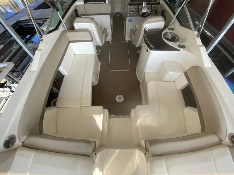 Slide: The Image of 2012 Sea Ray 270 SLX boat interior with spacious seating and modern helm. - 16