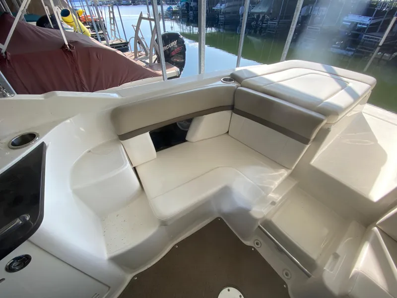 Slide: The Image of 2012 Sea Ray 270 SLX boat interior with white seating and lake view. - 19