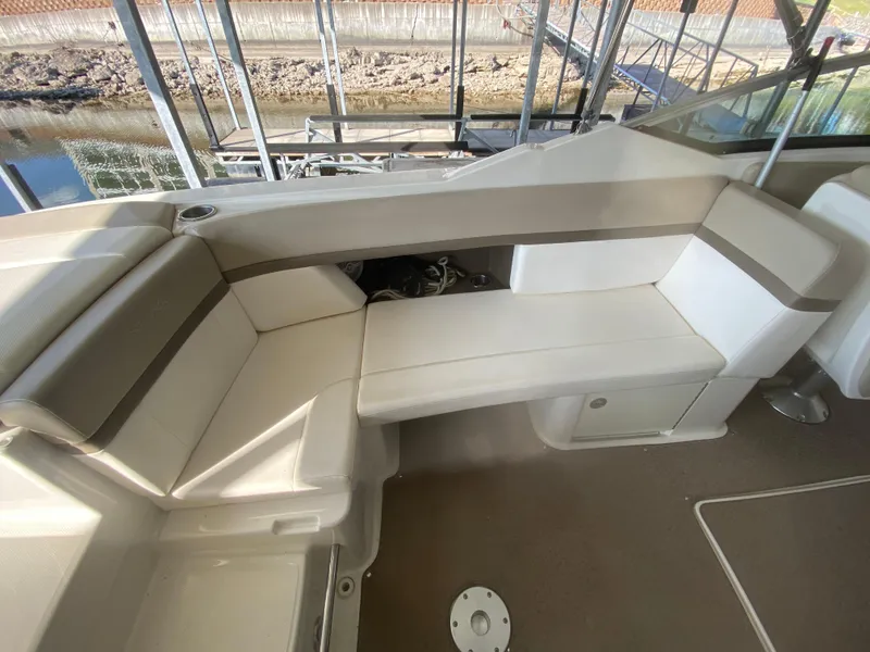 Slide: The Image of Interior seating of 2012 Sea Ray 270 SLX boat, featuring white and beige upholstery. - 20