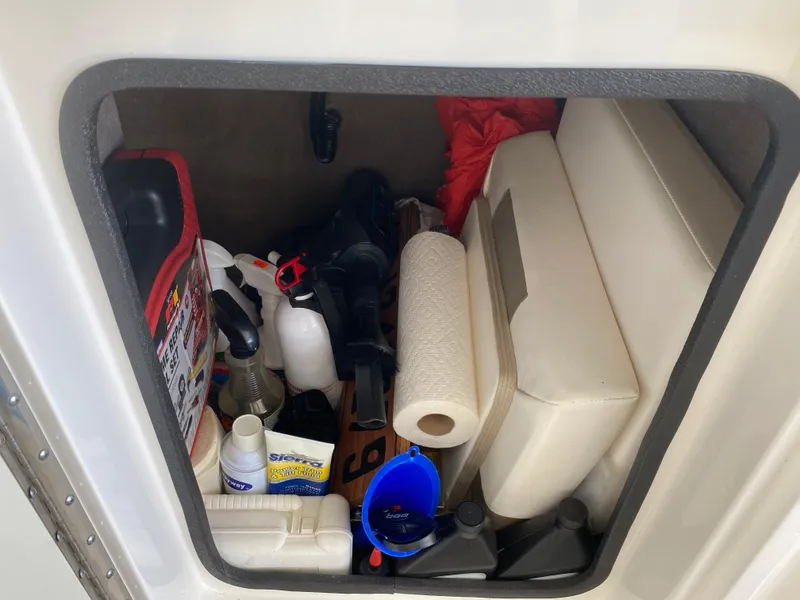 Slide: The Image of Storage compartment of a 2012 Sea Ray 270 SLX boat, filled with supplies and equipment. - 23