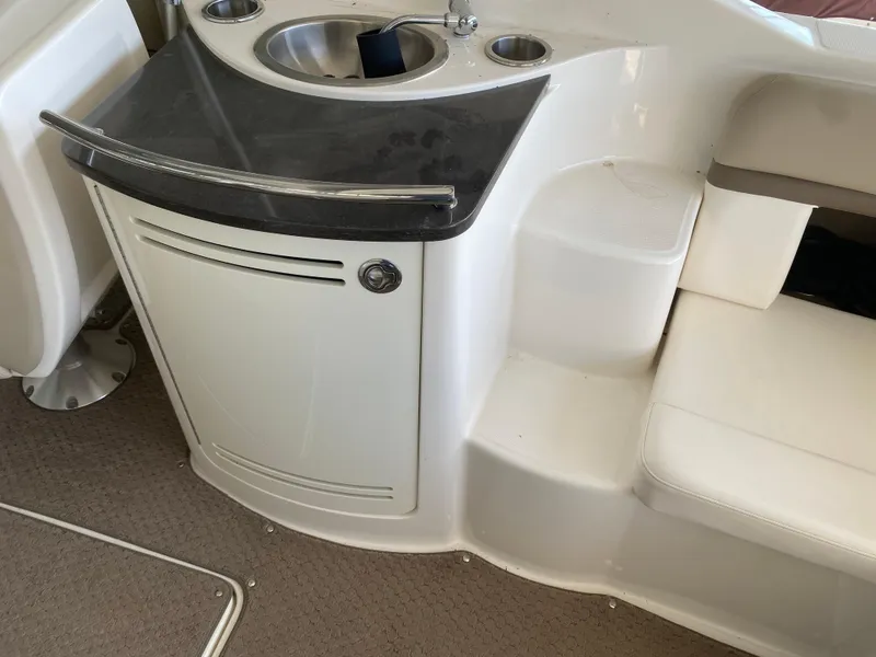 Slide: The Image of 2012 Sea Ray 270 SLX boat interior with sink and seating area. - 24