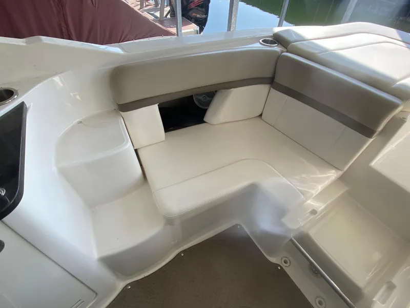 Slide: The Image of 2012 Sea Ray 270 SLX boat interior with beige seating and cup holders. - 25