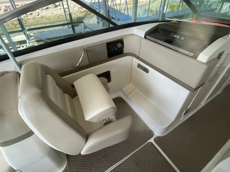 Slide: The Image of Interior of 2012 Sea Ray 270 SLX boat with beige seating and dashboard. - 27