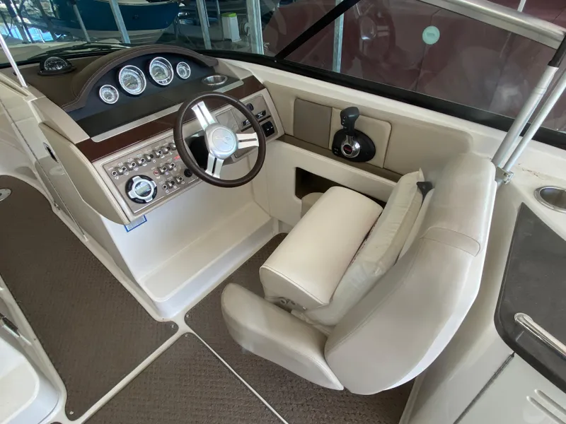 Slide: The Image of Interior view of 2012 Sea Ray 270 SLX boat cockpit with steering wheel and controls. - 30