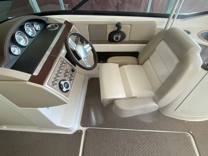 Slide: The Image of 2012 Sea Ray 270 SLX boat interior with steering wheel and control panel. - 31