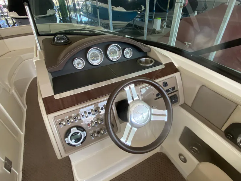 Slide: The Image of Interior dashboard of a 2012 Sea Ray 270 SLX boat with steering wheel and gauges. - 32