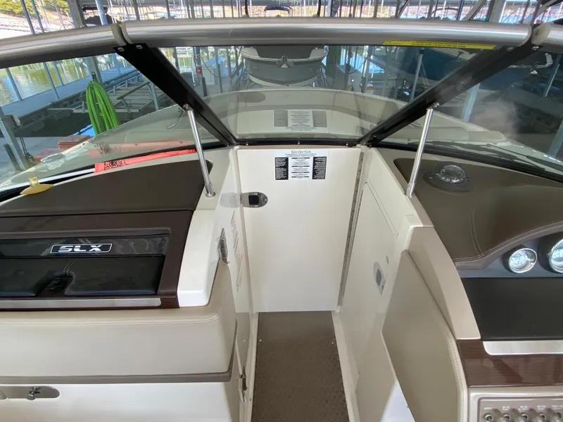 Slide: The Image of 2012 Sea Ray 270 SLX boat interior with dashboard and windshield view. - 36