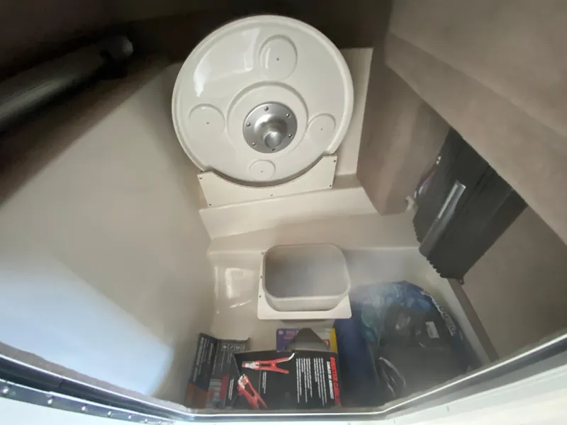 Slide: The Image of Interior storage compartment of a 2012 Sea Ray 270 SLX boat with various items. - 37
