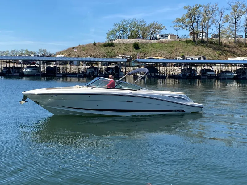 Slide: The Image of 2012 Sea Ray 270 SLX boat on calm water near a marina. - 4