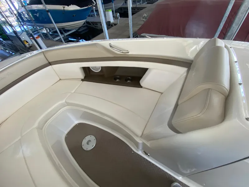 Slide: The Image of 2012 Sea Ray 270 SLX boat interior with beige seating and brown accents. - 40